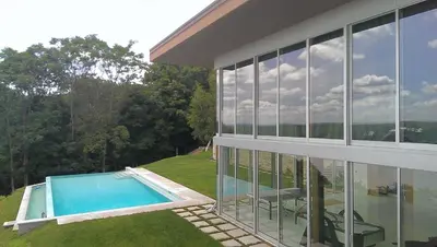 a house with a swimming pool in front of it at Extraordinary Private Retreat Near NYC in Highland
