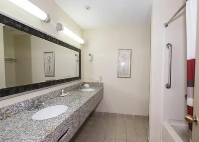 a bathroom with two sinks and a large mirror at Red Roof Inn Hartford - Vernon in Vernon