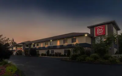 a hotel with a sign on the side of it at Red Roof Inn Hartford - Vernon in Vernon