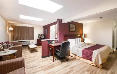 a hotel room with a bed and a desk at Red Roof Inn Hartford - Vernon in Vernon