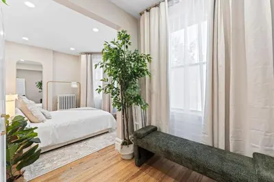 a bedroom with a bed and a large window at Casa Kanso in Jersey City