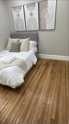 a bedroom with a bed and a wooden floor at Casa Kanso in Jersey City