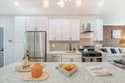 a kitchen with a counter with a bowl of fruit on it at Pent House on Bruckner New Luxe 2BR 2BA King Bed Fast Wi-Fi 15 Mins to Times Square in Mott Haven