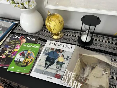a table with two magazines and a vase with flowers at Private Mountain Retreat On 10 Acres The Perfect Family Escape in Cheshire