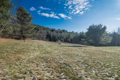 a field of grass with trees in the background at Private Mountain Retreat On 10 Acres The Perfect Family Escape in Cheshire
