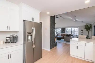 a kitchen with white cabinets and a stainless steel refrigerator at Private Mountain Retreat On 10 Acres The Perfect Family Escape in Cheshire