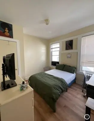 a bedroom with a bed and a flat screen tv at Vibrant home all to yourself in Newark