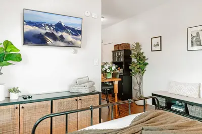 a room with a bed and a desk with a picture on the wall at Studio in Little Italy in New Haven