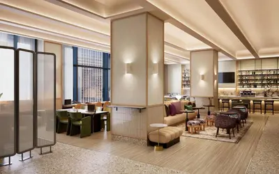 a lobby of a hotel with tables and chairs at Kimpton Era Midtown New York by IHG in New York