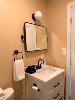 a bathroom with a sink and a mirror on the wall at Modern 3-Bedroom Retreat with Fire Pit - Ski at Big Bear - Mountain Views in Eldred