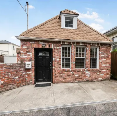 a red brick house with a black door at Cozy cottage close to NYC in Yonkers