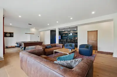 a living room with a couch and a pool table at Windham Slopes - Ski-In-Out, Hot Tub & Fire Pit in Windham