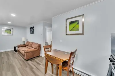 a living room with a table and a couch at The Main Lineup Apt 4 - All Star Baseball Rentals in Oneonta