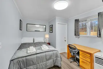 a bedroom with a bed and a desk and a computer at The Main Lineup Apt 4 - All Star Baseball Rentals in Oneonta