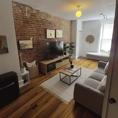 a living room with a brick wall at The Helton Suites at Midtown in New York