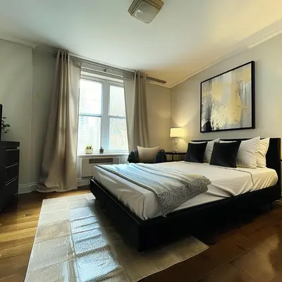 a bedroom with a large bed and a window at The Helton Suites at Midtown in New York