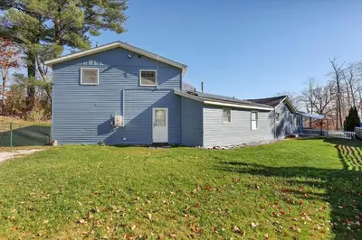 a blue house with a yard in front of it at 13-Min Jiminy, Fave, Hot Tub, Lg Open LR, Family in Pittsfield