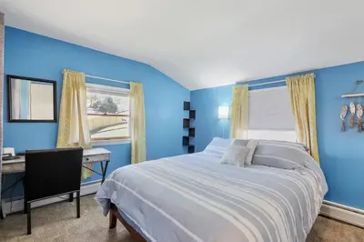 a blue bedroom with a bed and a desk at 13-Min Jiminy, Fave, Hot Tub, Lg Open LR, Family in Pittsfield