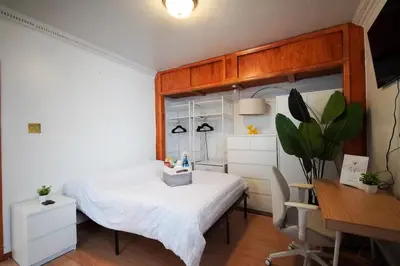 a bedroom with a bed and a desk and a table at Private Studio Near NYC - Easy Commute & Workspace in Guttenberg
