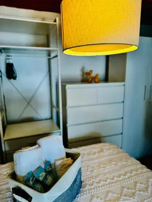 a basket of toiletries sitting on a table next to a lamp at Private Studio Near NYC - Easy Commute & Workspace in Guttenberg