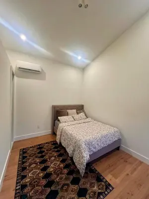 a small bedroom with a bed and a rug at Pocono Ski Home Fire Pit Game Room EV in Tobyhanna