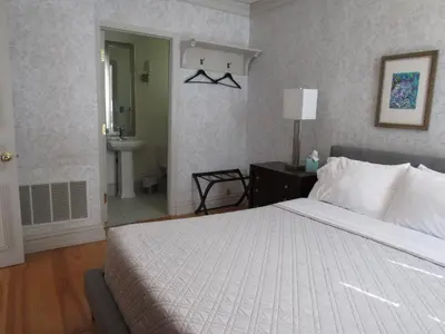 a bedroom with a large bed and a bathroom at Washington Park Inn in Albany