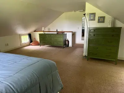 a bedroom with a bed and a dresser at Peaceful Meadow Retreat in Granby