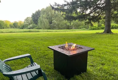 a fire pit sitting next to a bench in a field at Peaceful Meadow Retreat in Granby