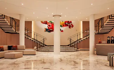 a lobby of a building with stairs and a sculpture at The William Vale in Brooklyn