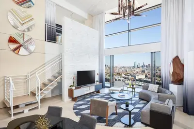 an apartment living room with a view of the city at The William Vale in Brooklyn