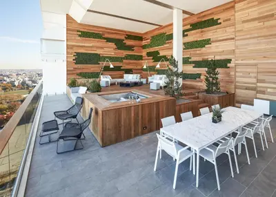 a patio with a table and a tub on a deck at The William Vale in Brooklyn