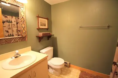 a bathroom with a white toilet and a sink at Mount Snow Chalet Loft Condo With VIEW ! in Dover