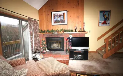 a living room with a tv and a fireplace at Mount Snow Chalet Loft Condo With VIEW ! in Dover
