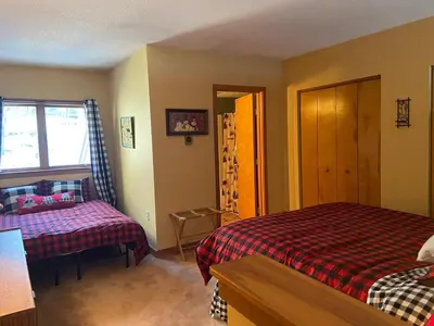 a bedroom with a bed and a couch and a window at Mount Snow Chalet Loft Condo With VIEW ! in Dover