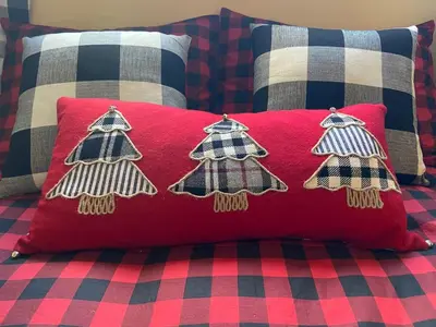 a red pillow with three christmas tree pillows on a bed at Mount Snow Chalet Loft Condo With VIEW ! in Dover