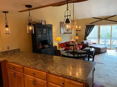 a kitchen with a counter top and a living room at Mount Snow Chalet Loft Condo With VIEW ! in Dover