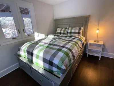a bedroom with a bed with a checkered blanket at Cozy Lake House - Salisbury/Lakeville in Salisbury