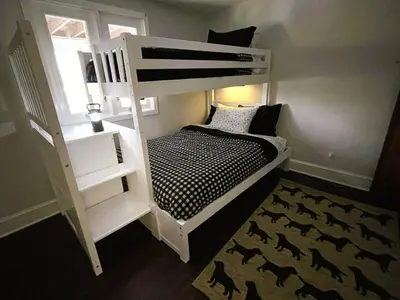 a bedroom with a bunk bed with a black and white at Cozy Lake House - Salisbury/Lakeville in Salisbury