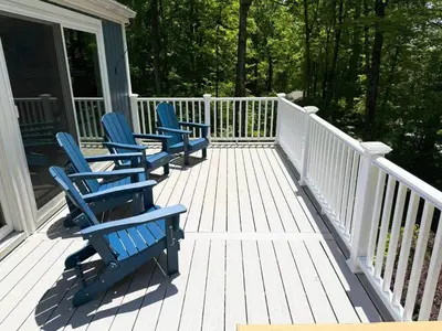 three blue chairs sitting on a porch of a house at Cozy Lake House - Salisbury/Lakeville in Salisbury