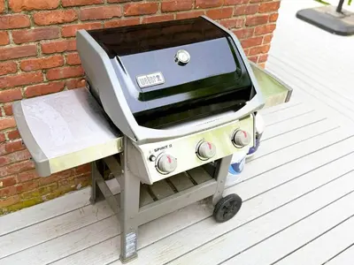 a grill sitting on a cart next to a brick wall at Cozy Lake House - Salisbury/Lakeville in Salisbury