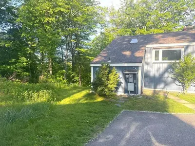 a house with a yard with a driveway at Cozy Lake House - Salisbury/Lakeville in Salisbury