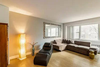 a living room with a couch and a mirror at Piece of mind in Harlem in New York