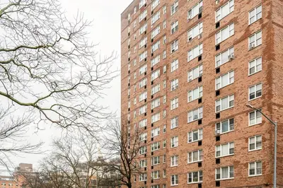 a tall red brick building with many windows at Piece of mind in Harlem in New York
