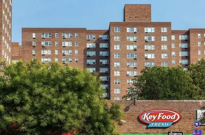 a coca cola sign in front of a large building at Piece of mind in Harlem in New York