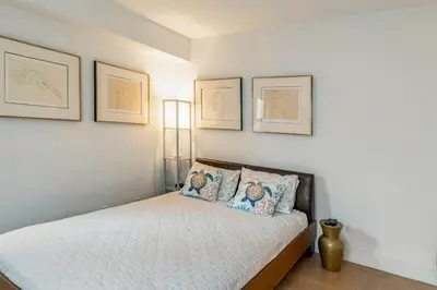 a bedroom with a bed with three pictures on the wall at Piece of mind in Harlem in New York