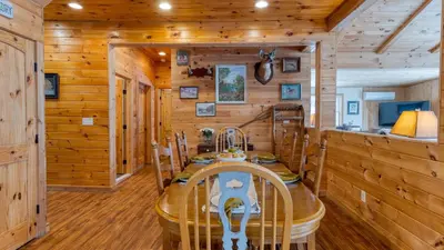 a dining room in a log cabin with a table and chairs at Mins to Hunter Mountain • Sleeps 36 • Pool Spa Games Bar Cozy Peaks Lodge by AvantStay in Tannersville