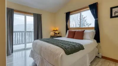 a bedroom with a bed and a large window at Mins to Hunter Mountain • Sleeps 36 • Pool Spa Games Bar Cozy Peaks Lodge by AvantStay in Tannersville
