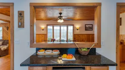 a kitchen with a counter top and a window at Scenic Catskills Retreat • Pool Hot Tub Game Room Lake Views Mountainview Estate by AvantStay in Jewett