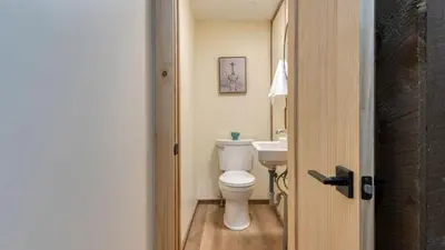a bathroom with a toilet and a sink at Sleeps 40 • Heated Pool • Hot Tub • Fire Pit • Game Room Brookside Mountain Retreat by AvantStay in Stephentown