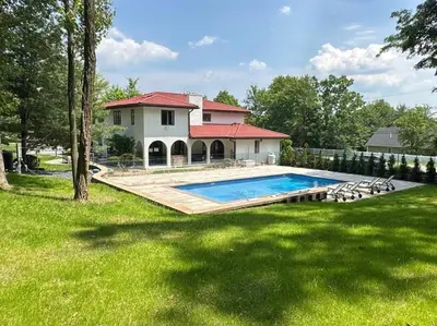 a house with a swimming pool in a yard at Mediterranean villa hot tub fire place•fire pit in Monroe
